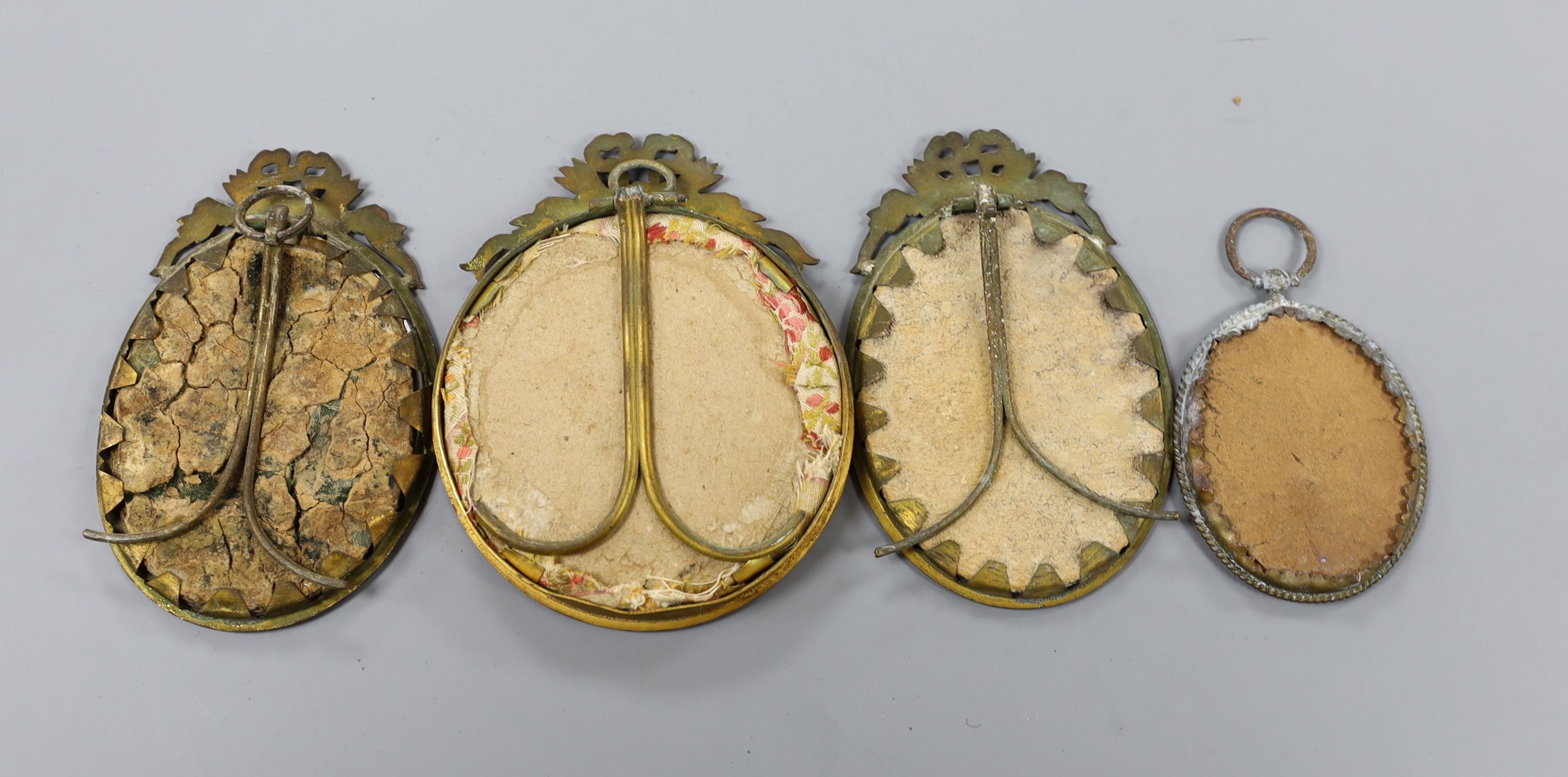 A group of four brass framed portrait miniatures